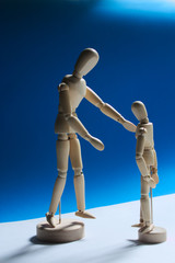 Family composition of a family. Wooden mannequin dummy father and son talking.