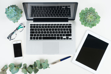 Laptop, tablet and phone with green plants mock up flat lay styled scene, top view, copy space on black screen background