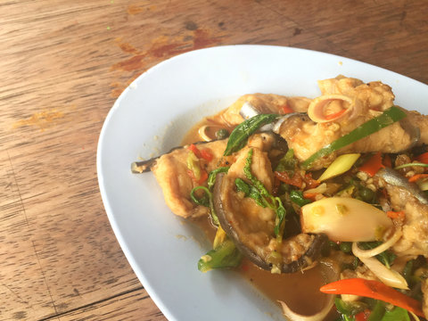 horizontal photo of fried spicy Mekong giant catfish with herb 