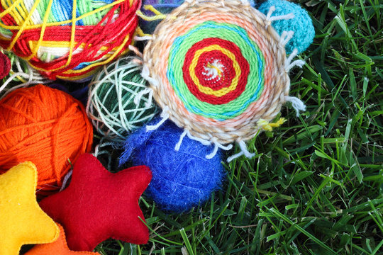 Colorful knitting balls from wool and fabric textile stars on gr