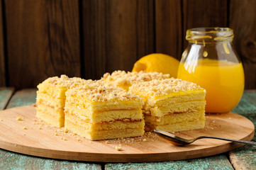 Homemade tasty lemon cake with lemon curd on bamboo plate