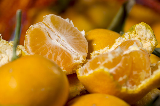 Segments of peeled orange tangerine between other citrus fruits