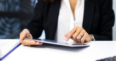 Woman using a tablet in her office.