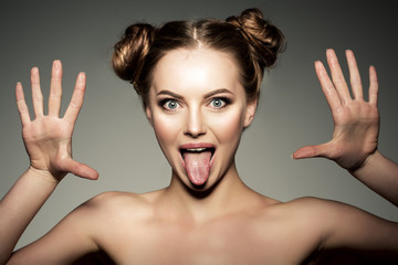 Emotional girl. Beautiful modern model shows tongue Positive wom