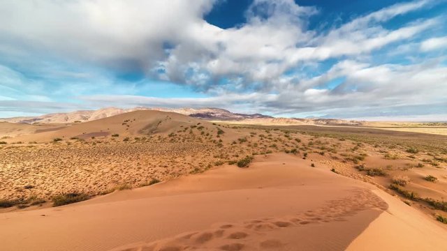 Beautiful clouds over sand dune in the national park Altyn Emel. 4K TimeLapse - September 2016, Almaty and Astana, Kazakhstan