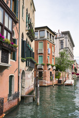 Venice cityscape. Canal Grande among old colorful brick houses in Venice, Italy.