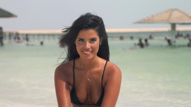 Sexy girl on the beach flirting