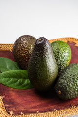 Green fresh avocado with leaves