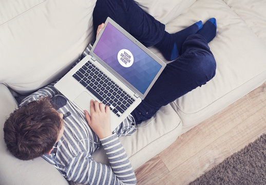 Young Person Lying on Couch with Laptop Mockup