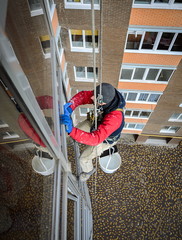 window washer cleans the residential building