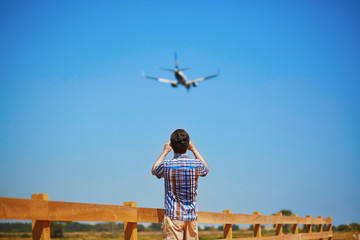 Man is looking at the glide path and landing plane