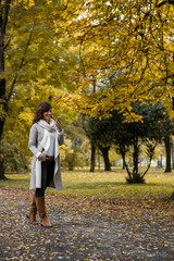 Woman in autumn park talking on smartphone