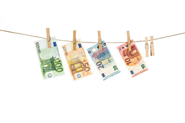 Euro banknotes hanging on clothesline on white background.