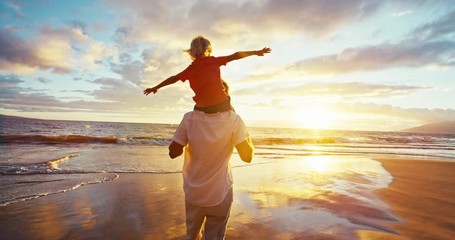 Happy father and son playing on the beach at sunset - Powered by Adobe