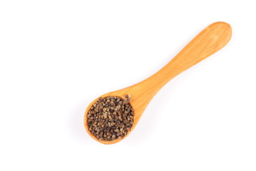 Decorticated cardamom seeds in a wooden spoon