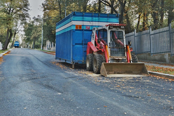 Fototapeta na wymiar 2016/09/24 - Chomutov, Czech republic - little red excavator parked on the street Politickych veznu in Chomutov city during a repair of sewerage