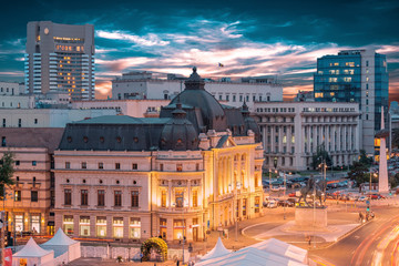 Long exposure aerial shot of the Revolution Square near Victoria Avenue in Bucharest, Romania. Traffic and historical buildings.Bucuresti - obrazy, fototapety, plakaty