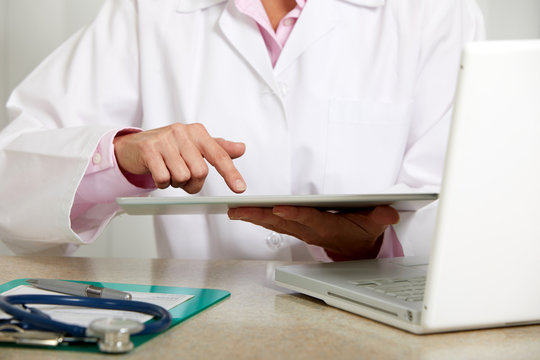 Doctor woman hands with tablet computer.
