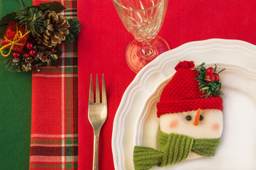 Holiday table setting with Christmas decorations.