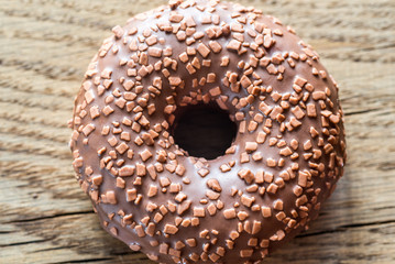 Chocolate donut on the wooden background