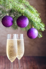 Two glasses of champagne with Christmas tree branch