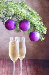 Two glasses of champagne with Christmas tree branch