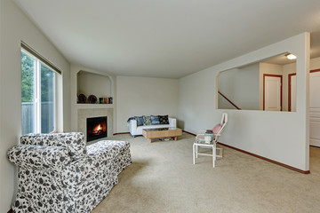 Light tones elegant living room with fireplace in the corner.