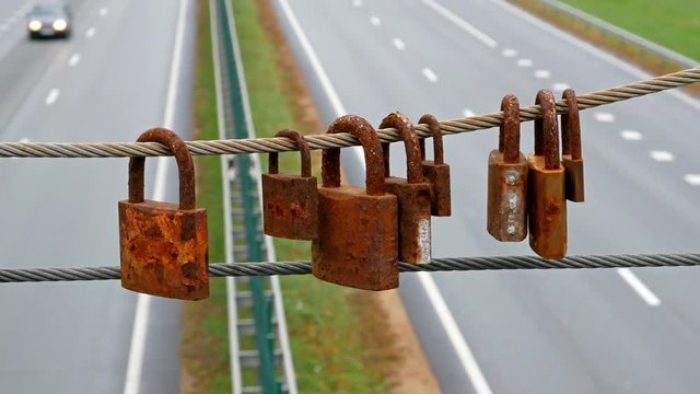 4K Rusted locks on the bridge over highway.