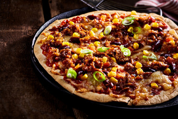 Large flat tortilla pizza in pan cropped on side