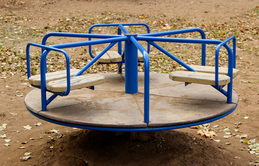 A blue carousel on a playground