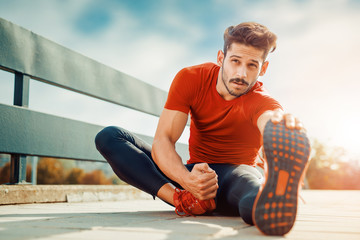 Portrait of a fitness man doing stretching exercises