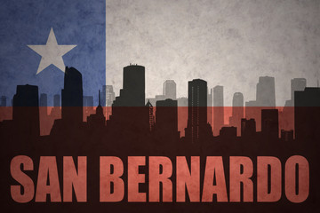 abstract silhouette of the city with text San Bernardo at the vintage chilean flag