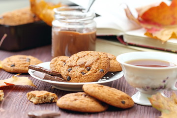 Autumn lifestyle with hot tea, sweets and yellow leaves
