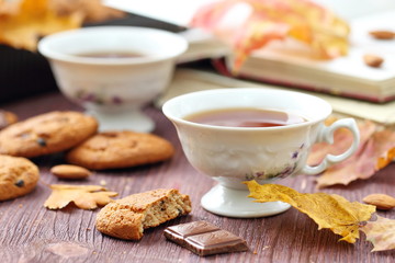 Autumn lifestyle with hot tea, sweets and yellow leaves