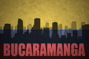 abstract silhouette of the city with text Bucaramanga at the vintage colombian flag