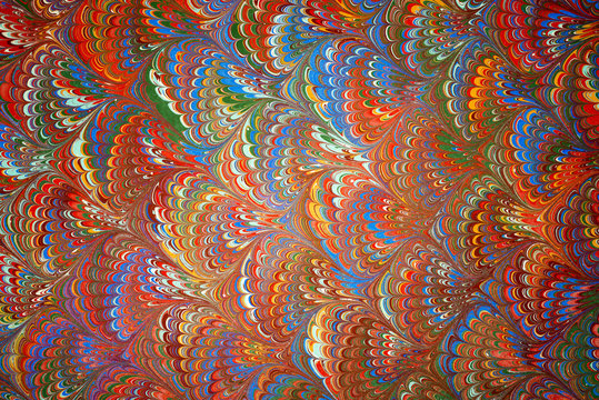 Ebru art. Traditional Turkish Ebru technique. Painting on water, followed by paper prints. Color paint ebru with waves and tile pattern.