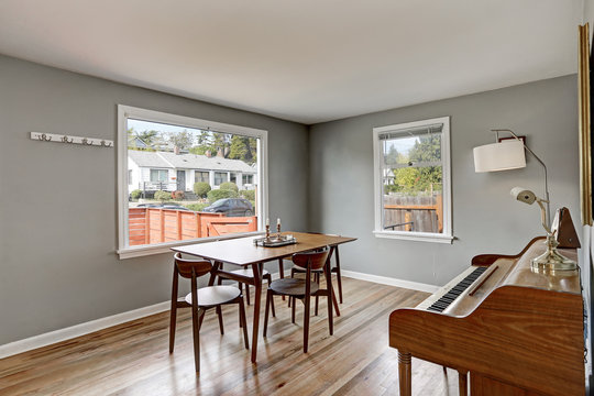 Gray dining room interior with piano