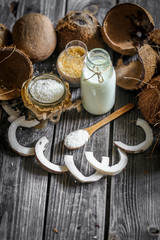 Fresh coconuts broken on wooden background