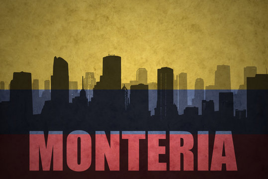 abstract silhouette of the city with text Monteria at the vintage colombian flag