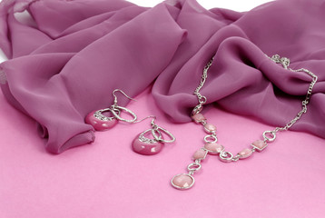 Fashion jewelry advertisement - pink bijouterie on velvet background