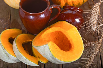 Pumpkin and ceramic pots on a wooden table