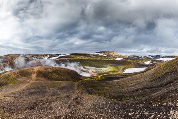 Dark Iceland landscape with green moss and steaming geothermal hot water, Iceland