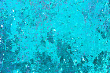 Cracked and peeling paint on the blue wall. Close-up view. Grunge old texture. Scratched and chipped surface.