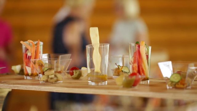 Various snacks on a buffet table at the event, the camera moves smoothly.