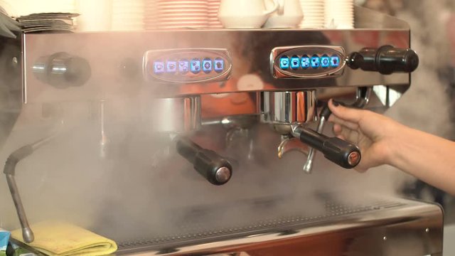 Cleaning the surface of a coffee machine.