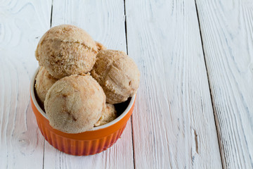 Homemade Ice cream with a persimmon, jam, cardamom on a white wo
