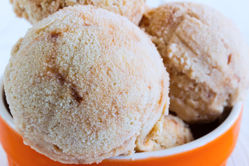 Homemade Ice cream with a persimmon, jam, cardamom on a white wo