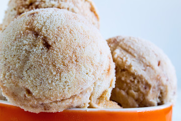 Homemade Ice cream with a persimmon, jam, cardamom on a white wo