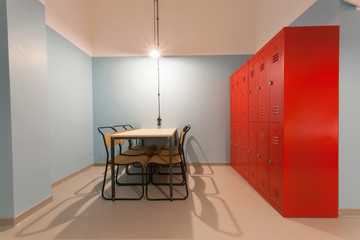 Modern room looks like prison with table and iron locker in a hostel for students