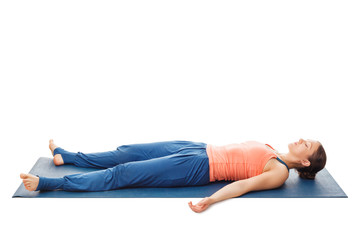 Women relaxes in yoga asana Savasana